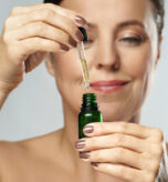 beautiful-middle-aged-woman-holding-bottle-with-co-2024-10-13-22-14-11-utc (2)
